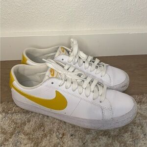 Nike Women’s White Leather Sneakers with Yellow Swoosh Accent